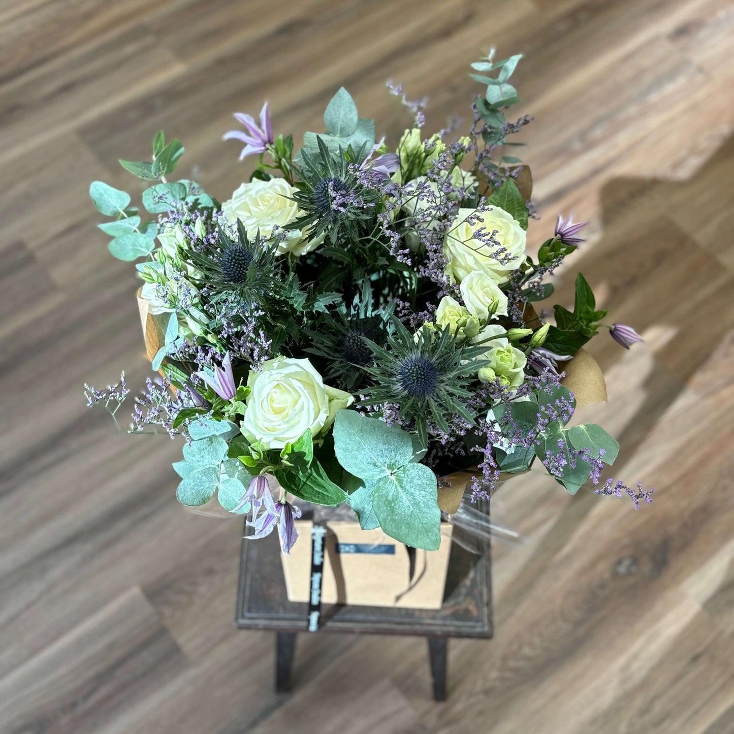 white roses lilac purple thistles blue eucalyptus fresh flower bouquet sympathy birthday gift