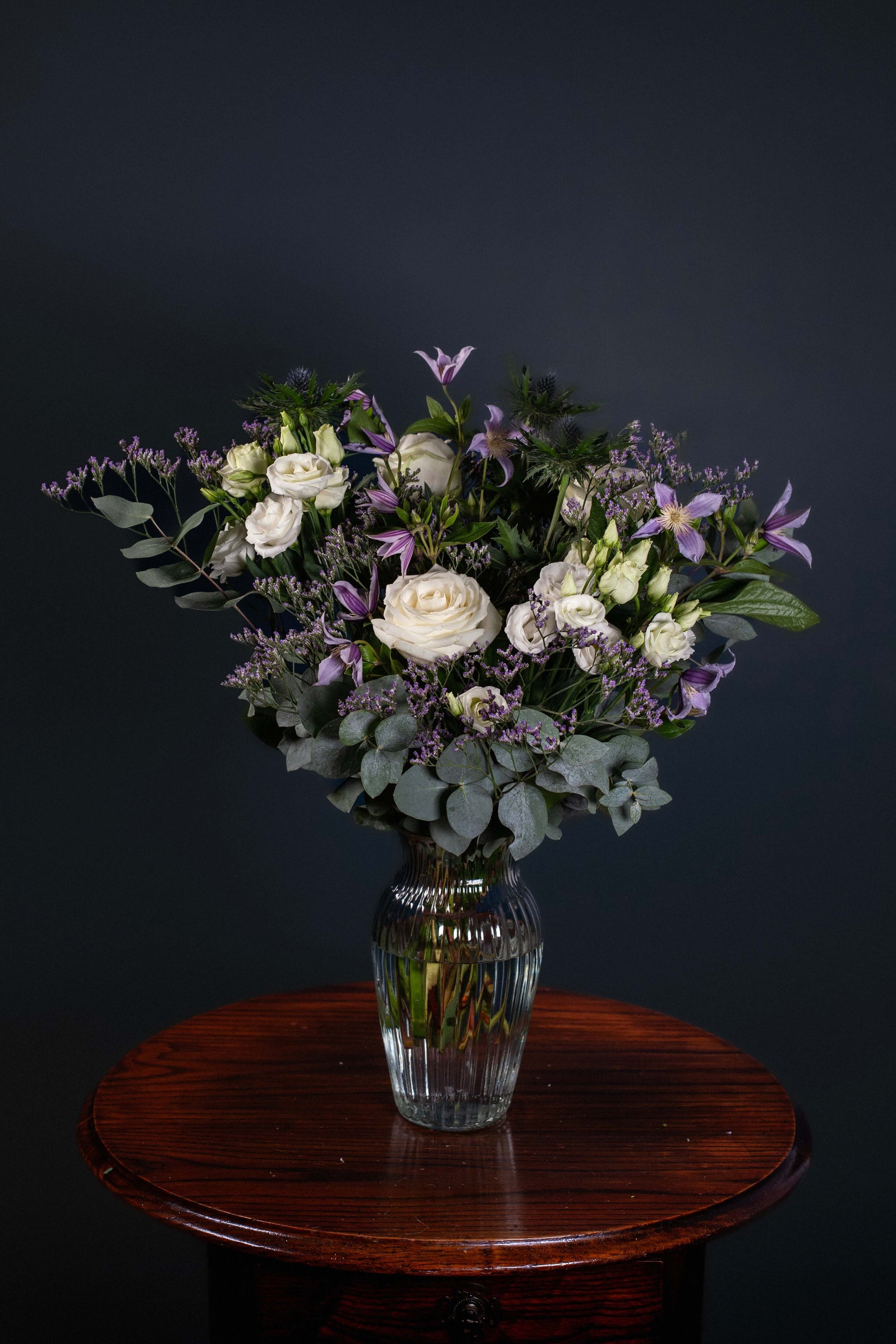 white roses lilac purple thistles blue eucalyptus fresh flower bouquet sympathy birthday