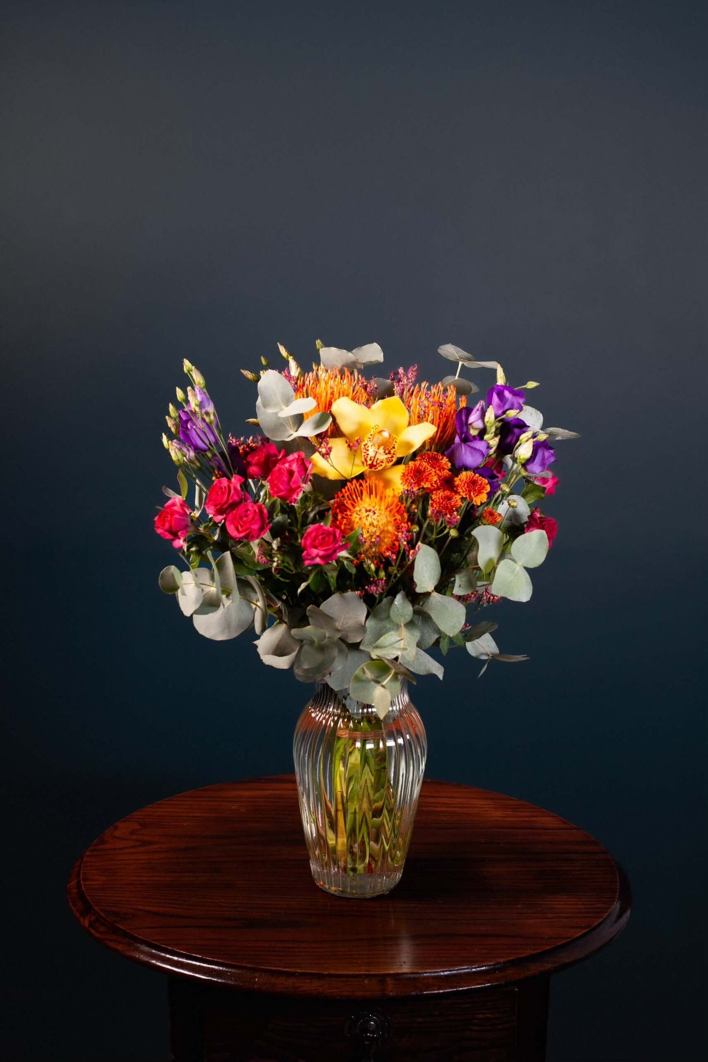 bright vibrant flowers colourful orange tropical cerise purple green yellow mixed bouquet vase
