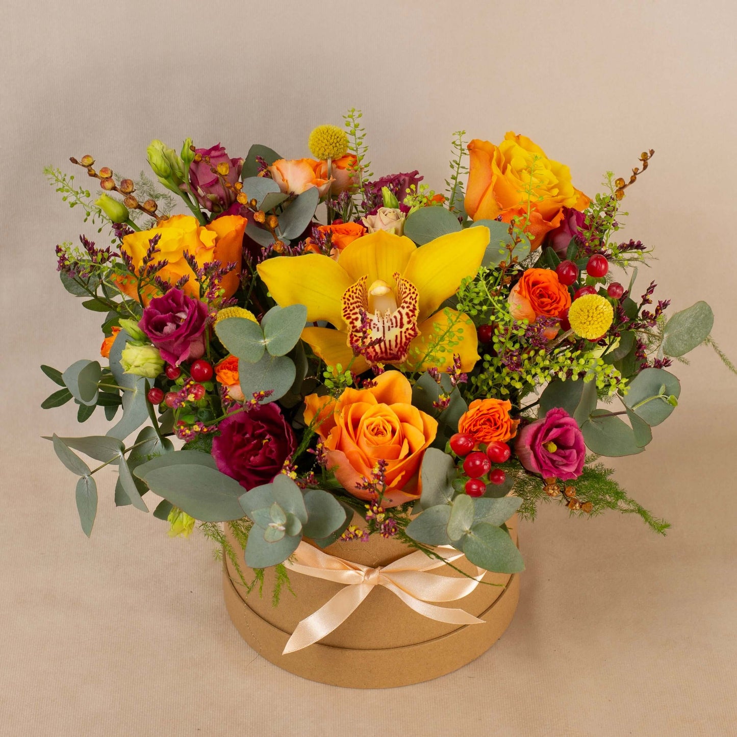 Bright orange yellow flowers in gift box floral arrangement delivery roses orchid